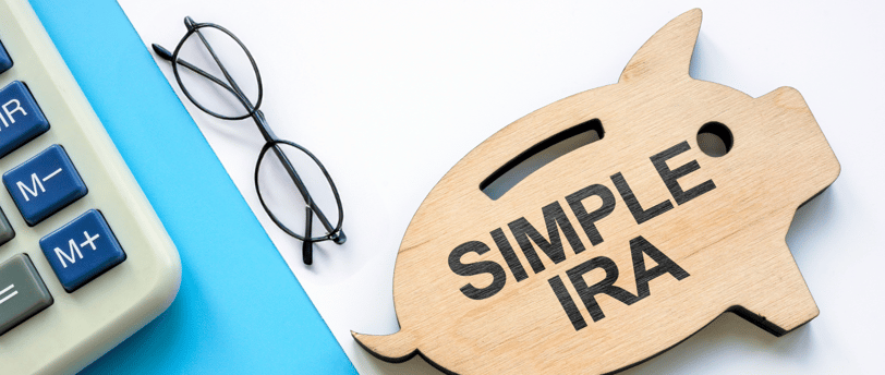 piggy bank a calculator and glasses for a simple ira