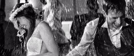 Bride and Groom having fun in the rain