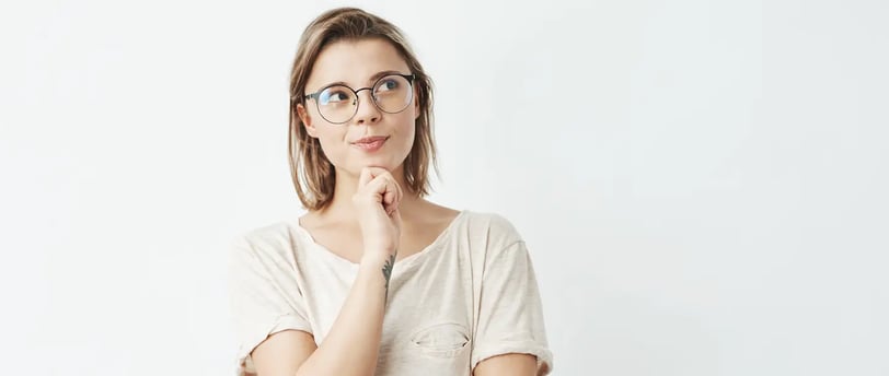 Thoughtful Young Woman with Glasses Looking Aside