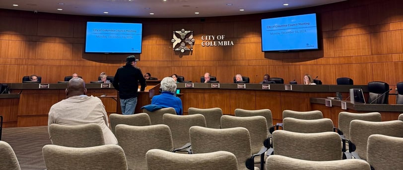 Man standing at the podium before city council.