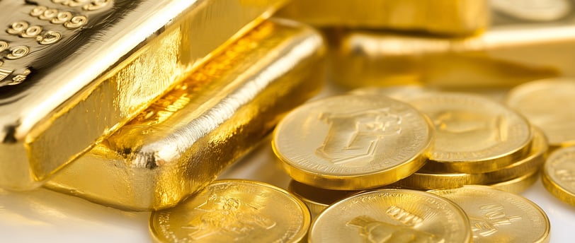 high quality gold bars and coins on a white surface