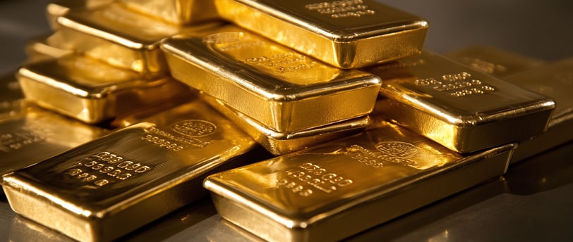 high quality gold bullion bars on a gray surface