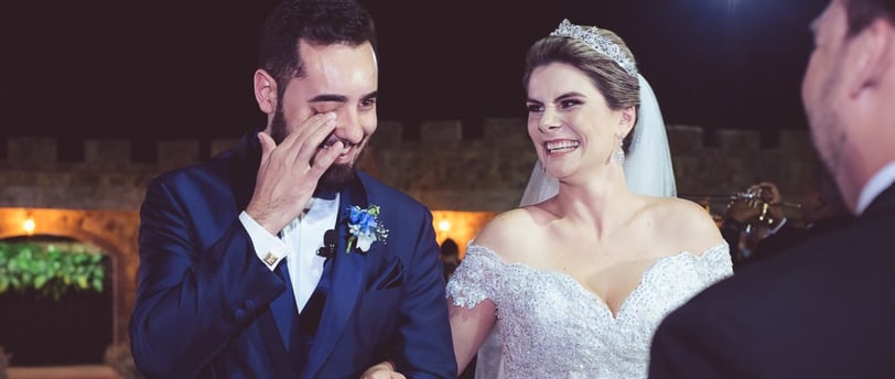 a bride and groom are standing in front of a wedding ceremony