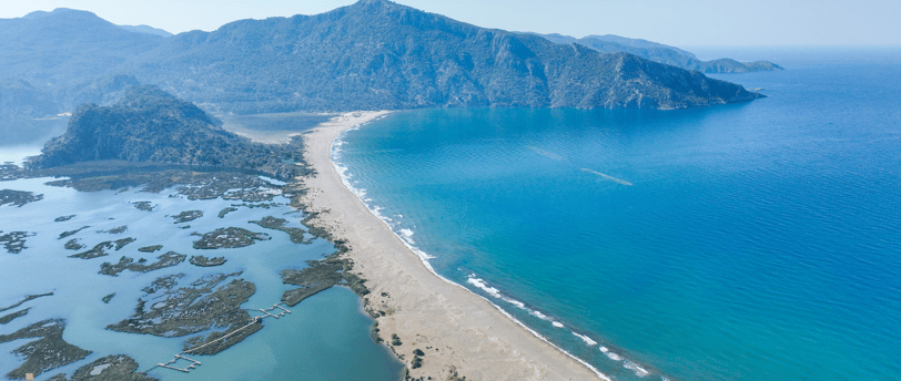 İztuzu Beach with a mountain in the background