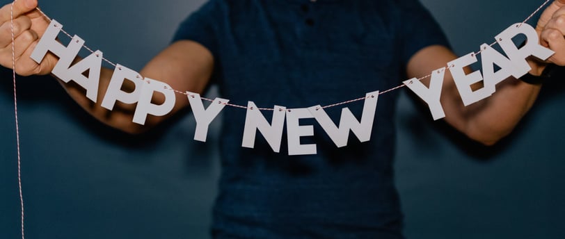 man holding a happy new year sign