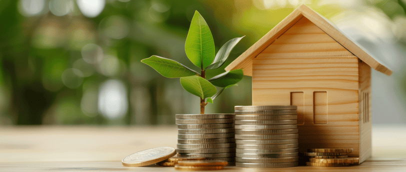 a mini house with coins and leaves sprouting for long term goals