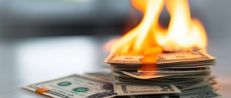 pile of money burning due to inflation
