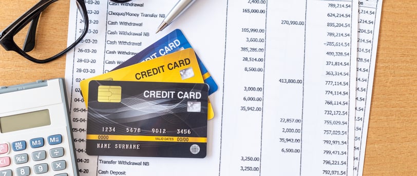 glasses a calculator and credit card for managing credit