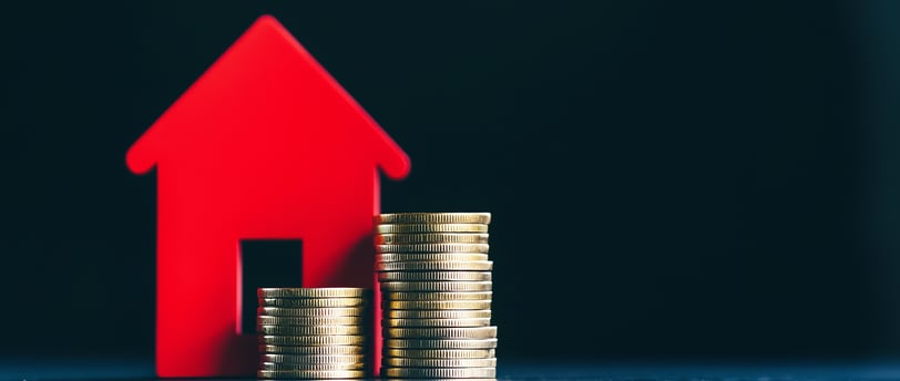 house with coins on side for real estate investing