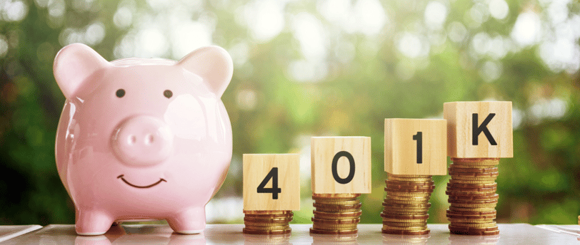 piggy bank and 401k blocks on gold coins