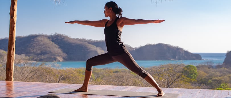 yoga pose on ocean view yoga deck