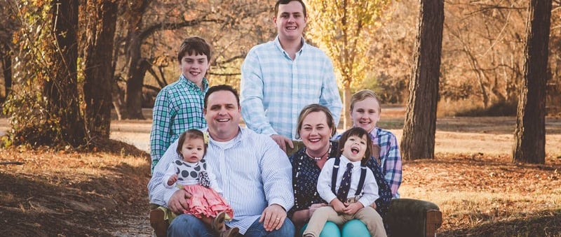 Foster Family sitting on a couch outside