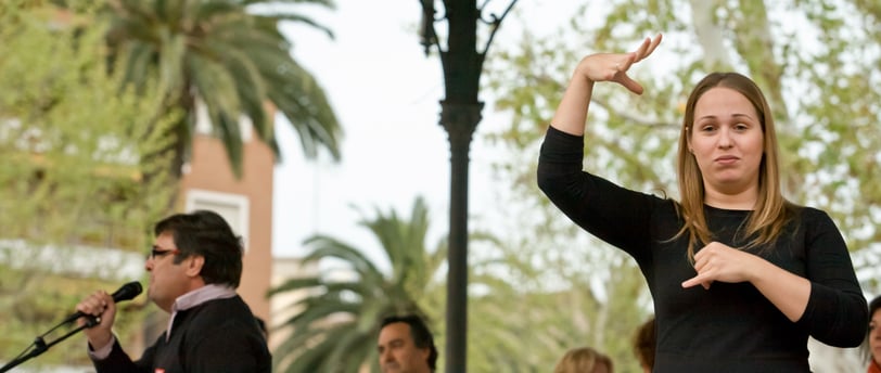 a sign language interpreter on stage at a public event