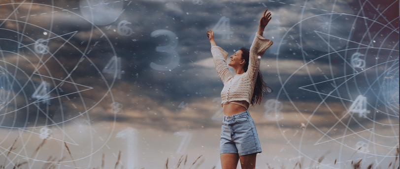 Woman with arms raised, standing in a field with dark sky, astrology and numerology symbols