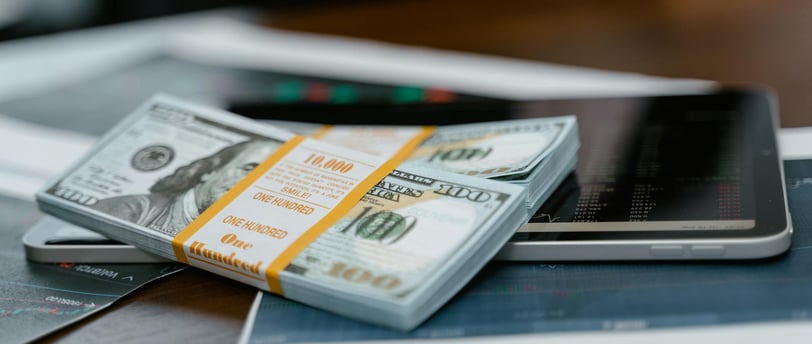 bunch of money and investing charts and graphs