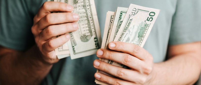 cash in someones hand for potential fees
