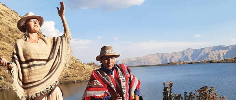 a woman in a traditional dress and a man in a hat opening sacred space