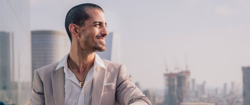 a man in a suit and a watch on a balcony
