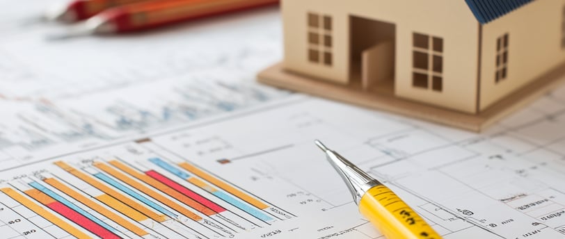 model house with pens and calculator