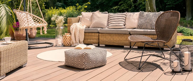 a patio with a couch and a chair