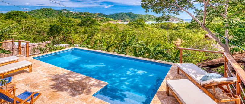 swimming pool overlooking jungle and ocean