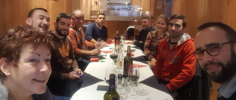 a group of people sitting around a table
