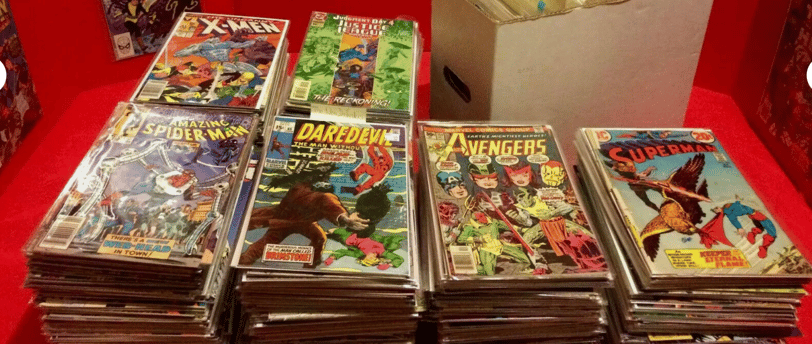 a table with a lot of comics books and comics