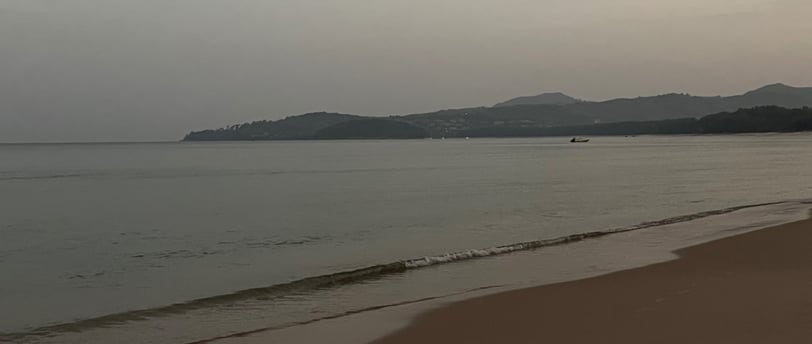 Bang Tao beach at sunrise with the mountains in the background