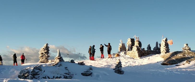a group of people standing on top of a snow covered hill