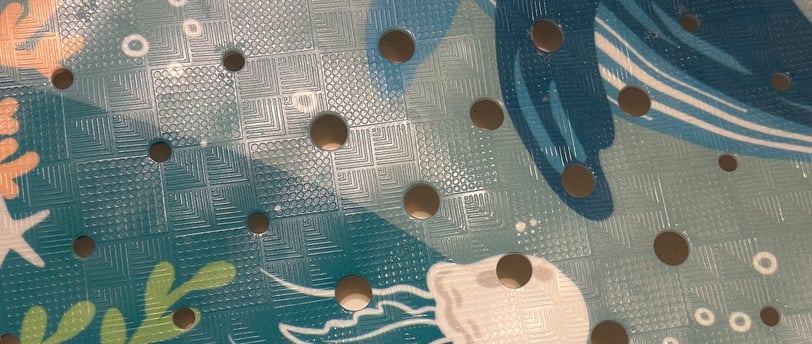 a picture of a bath tub mat with sea creatures on it