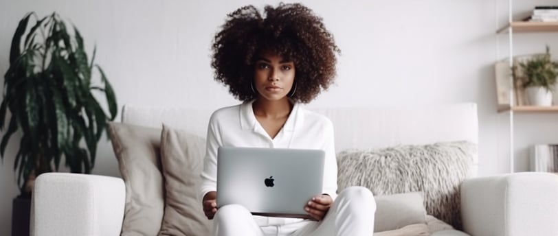 a woman sitting on a couch with a laptop