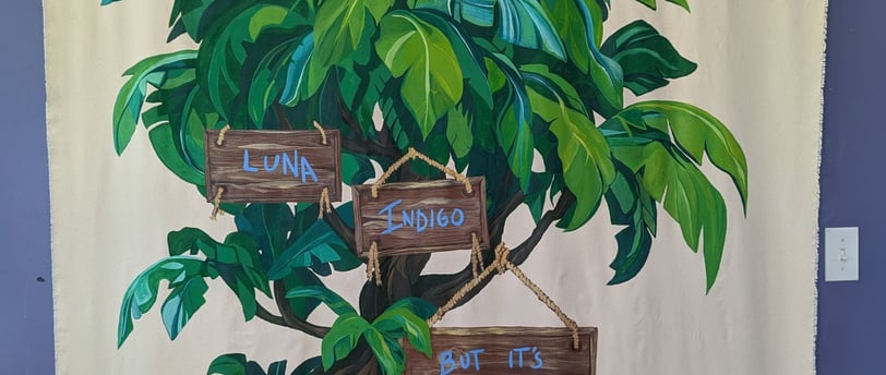 6-foot by 5-foot linen canvas tapestry mural of a lush jungle tree in greens and blues,, with signs and painted names.