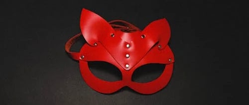 a red leather mask with a red cat mask on it
