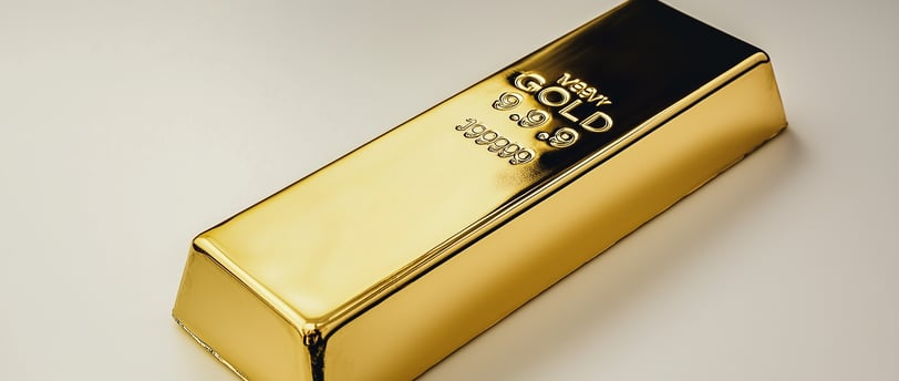 shiny gold bar on white surface