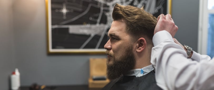 Hombre en una barbería cortándose el pelo