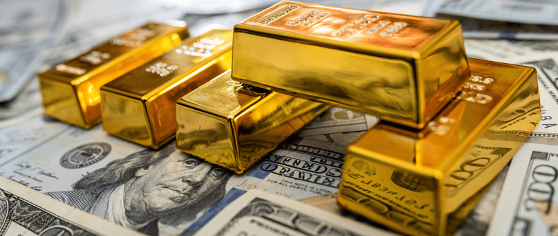 high quality gold bullion bars on top of US money