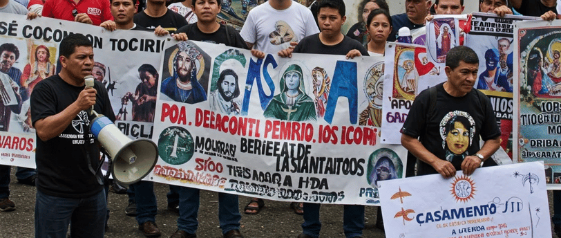 a group of people holding up signs and holding up signs