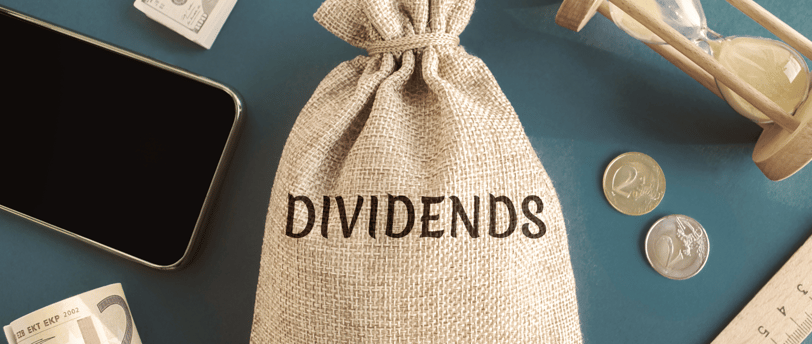 money bag a phone coins and a ruler for dividend growth investing