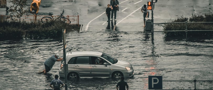 a car is parked in a flooded street