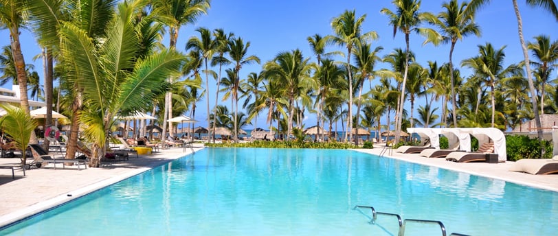 a pool with a swimming pool and lounge chairs