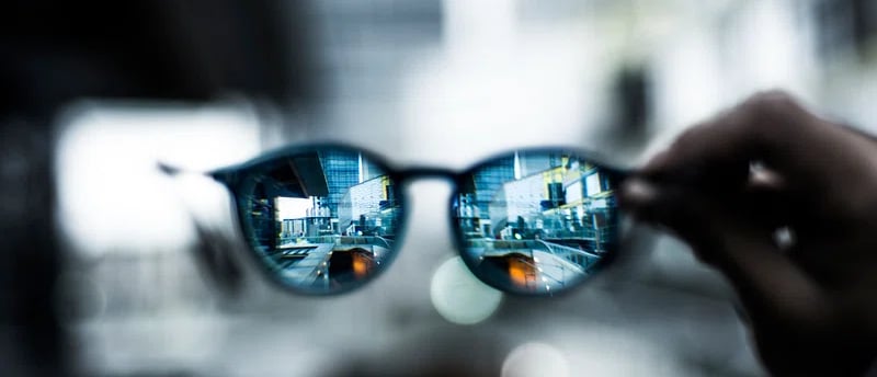 glasses showing a city in the lens