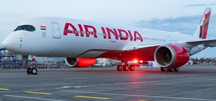 a large air india jetliner on a runway
