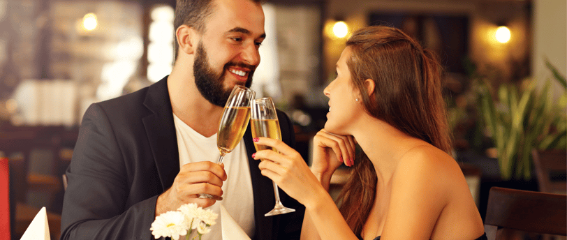 a man and woman are drinking champagne flutes