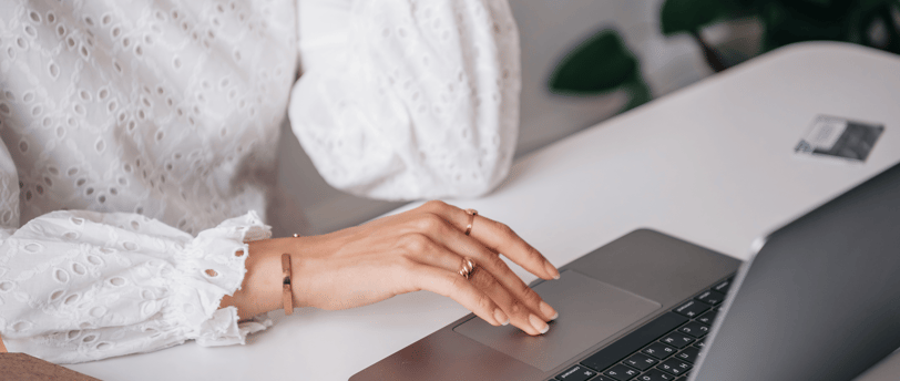 Close-up of woman typing on a laptop, seeking fertility information online