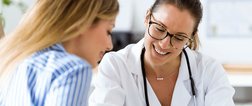 Female doctor warmly explaining fertility results to a patient