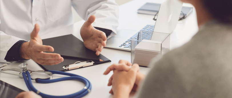 Fertility doctor explaining IVF process to patient during a clinic visit