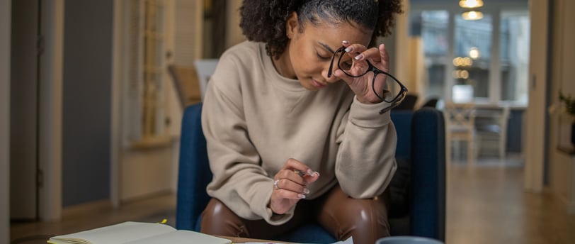 Woman calculating fertility treatment costs at home