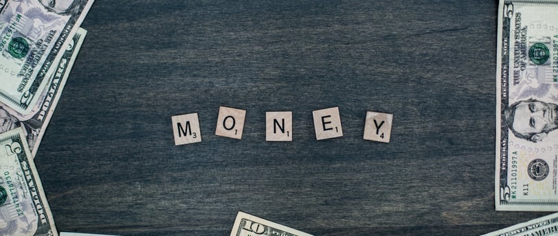 money spelled in wooden letters