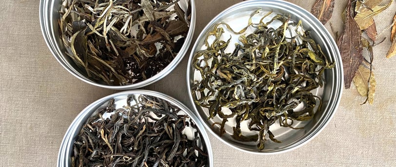 three tin cans of tea and some sort of tea
