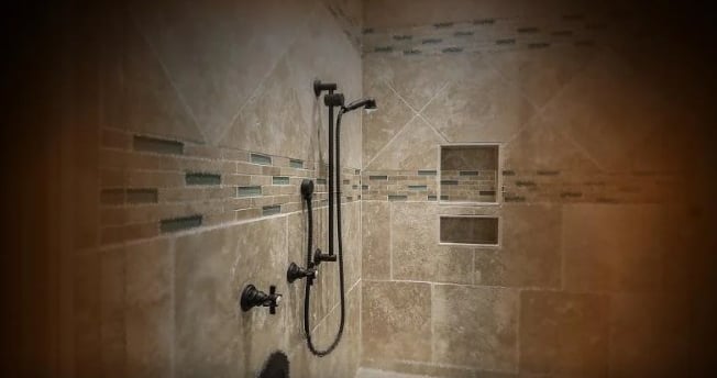 Modern tiled shower showing waterproofing work, emphasizing the need for expert evaluation in water damage insurance disputes